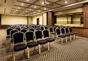 Rows of banquet chairs set for a conference in a hotel function room