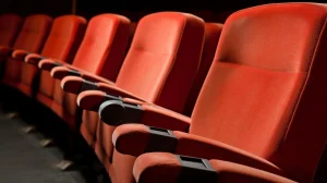 Theater seating vs auditorium seating: red cinema seats with tip-up pans and low backs